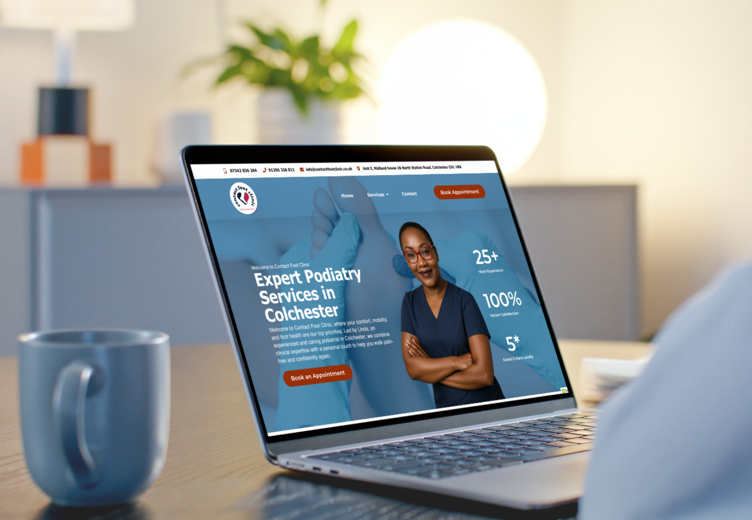 Contact Foot Clinic website shown on a laptop